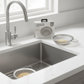 Stainless steel mesh sink strainers catching food debris in a modern kitchen sink