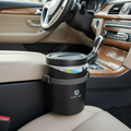 Compact car trash can with lid mounted between car seats in a clean car interior